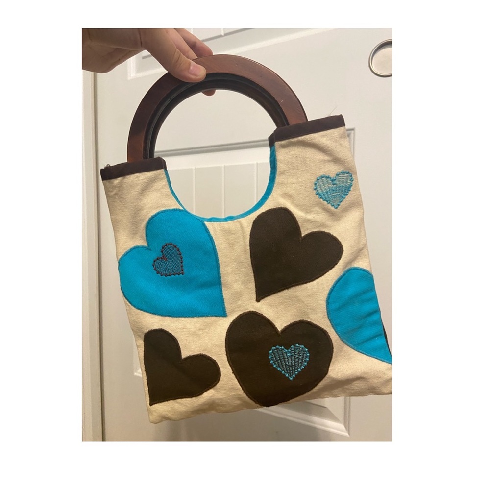 Small Blue and Brown purse with Heart designs on Beige background, wooden handle